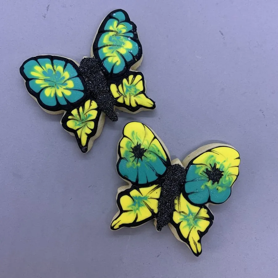 Bright blue and yellow butterfly cookies with black sparkle