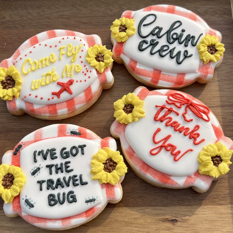 Piped cookies reading cabin crew, come fly with me, and thank you, with sunflowers
