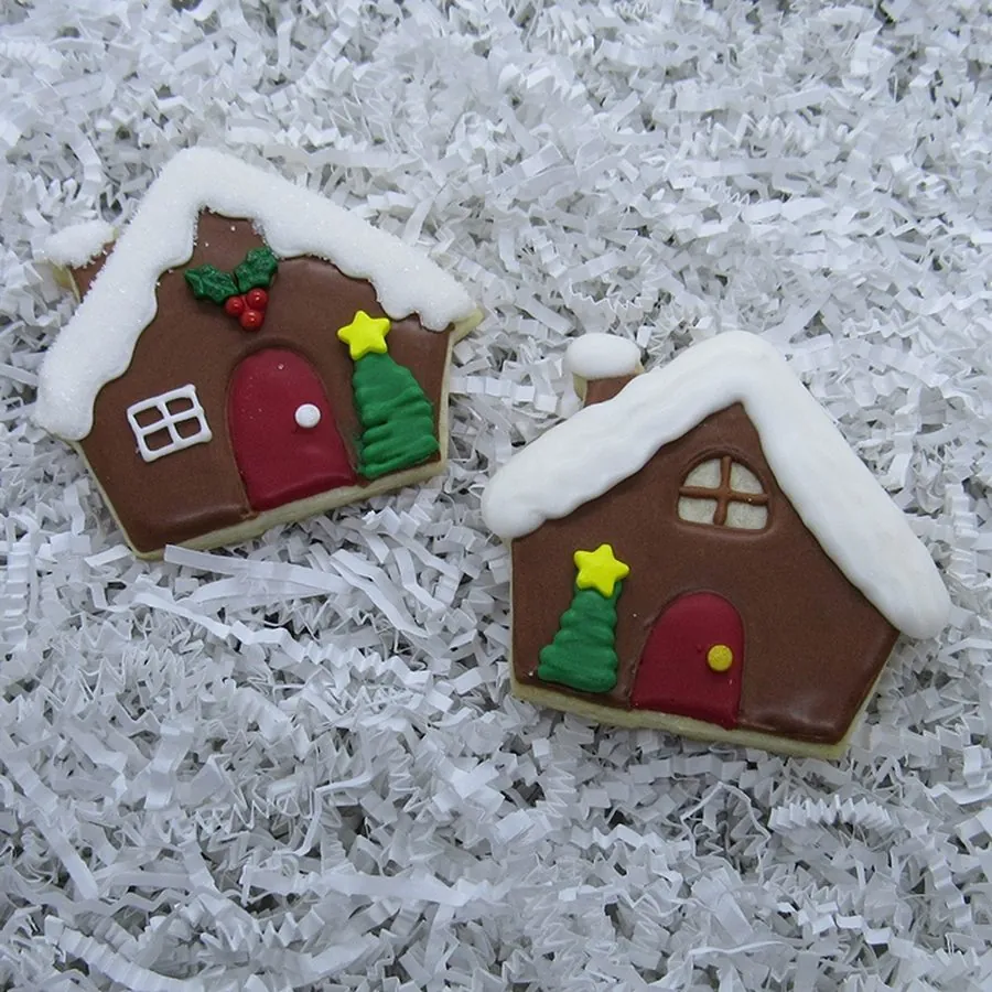 Gingerbread house cookies with piped snow and wreaths