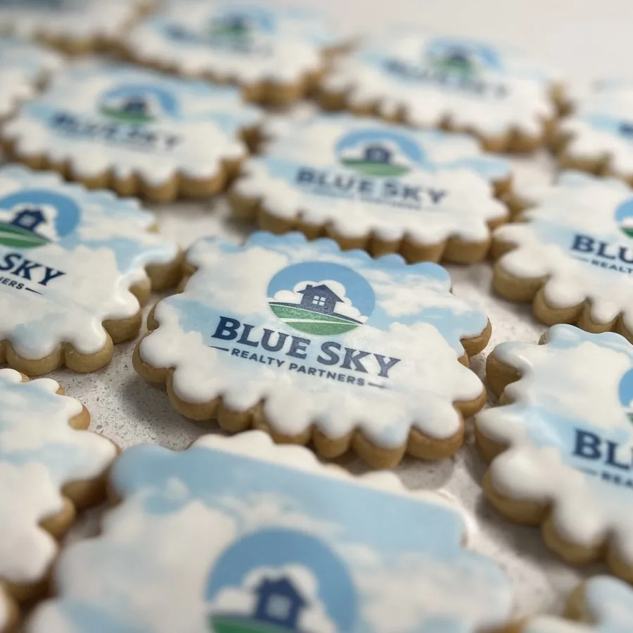 Scalloped cookies printed with the Blue Sky Realty Partners logo