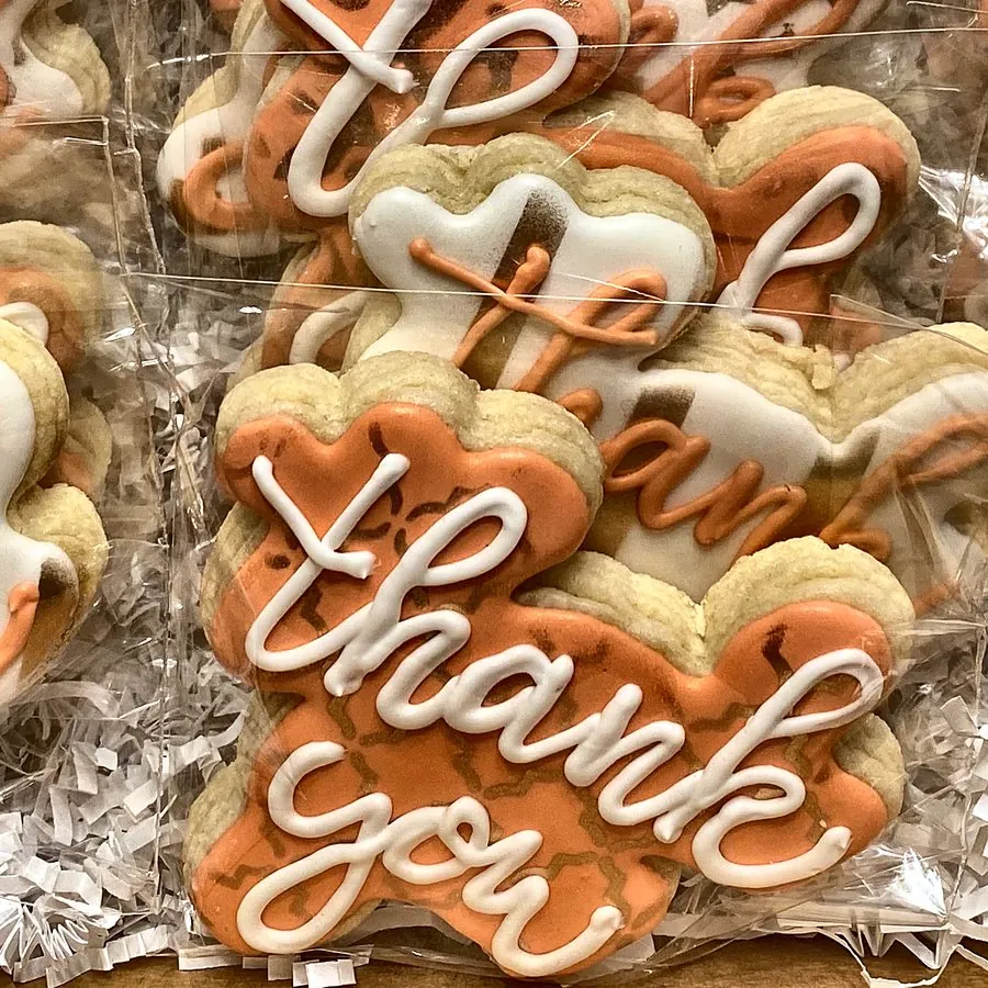 Individually wrapped orange and white thank-you cookies